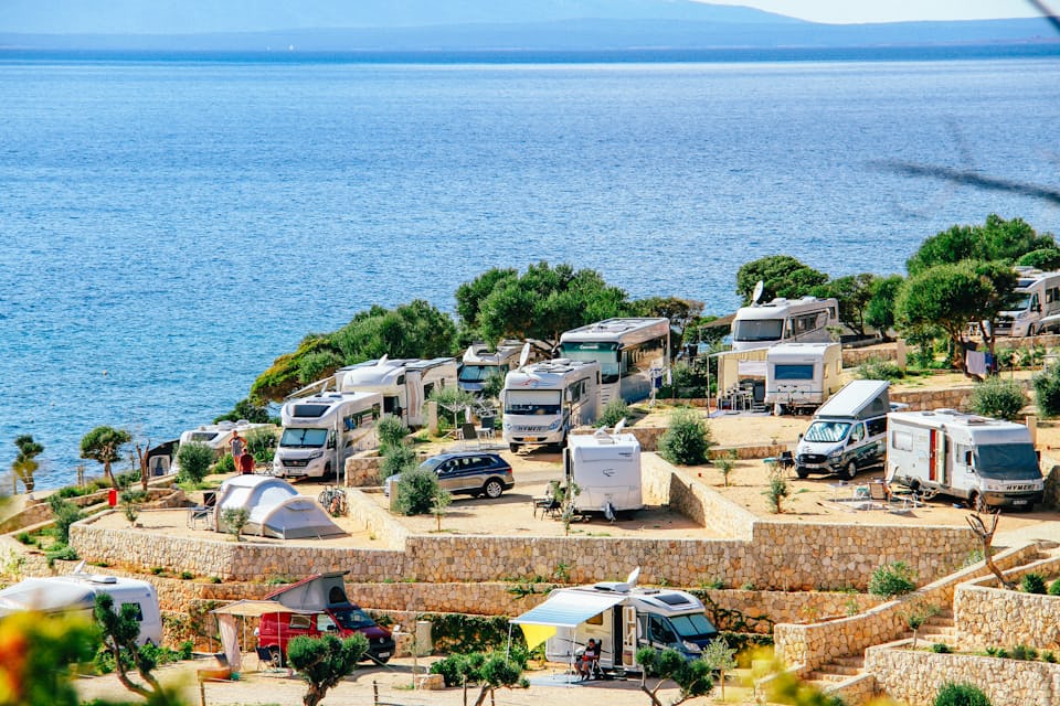 Aerial view of a coastal caravan and motorhome park full of pitches