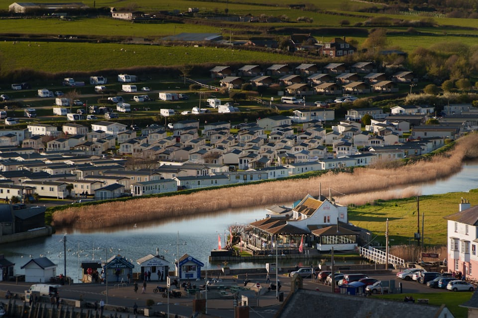 A touring caravan and campervan pitched at a UK campsite