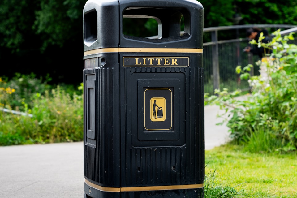 A litter and recycling bin on a path at a UK countryside campsite